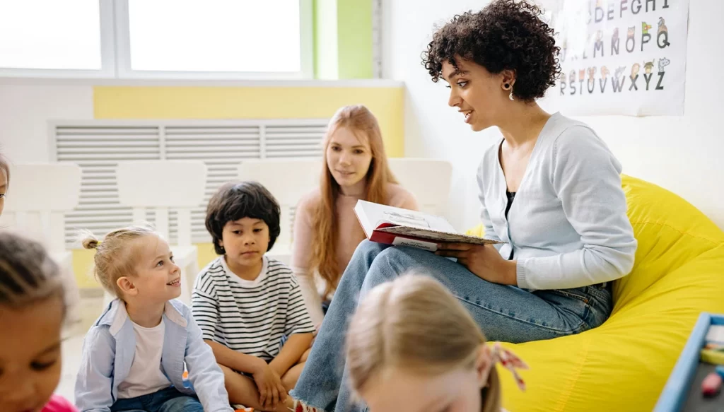 preschool teacher reading to students