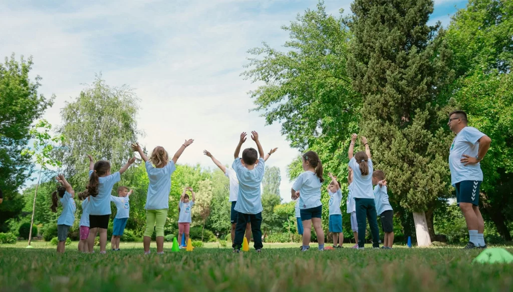 children in a park stretching while in a circle